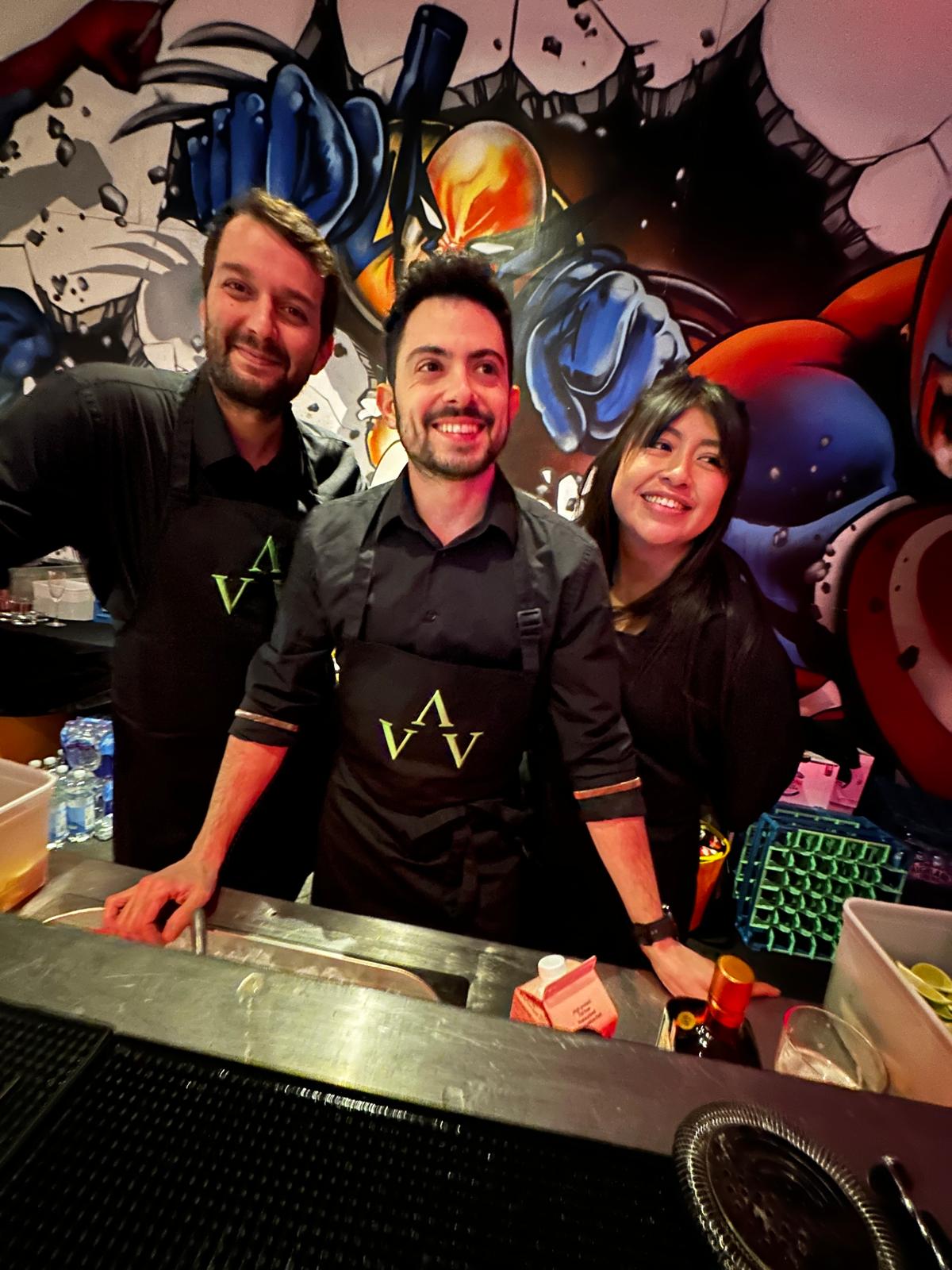 Professional Hire the Barman team smiling behind the bar at a private event